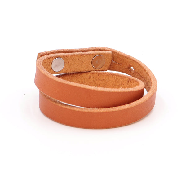 Double Wrap Cuff in Tan vegetableātanned leather with brass studs ā handcrafted leather wrist accessory